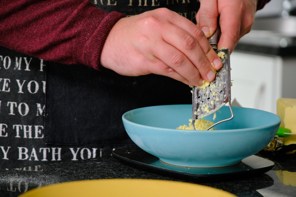 Butter is grated in preparation for puff pastry